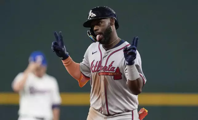 Atlanta Braves' Michael Harris II celebrates after his solo home run in the sixth inning of a baseball game against the Texas Rangers, Saturday, July 26, 2025, in Arlington, Texas. (AP Photo/Tony Gutierrez)