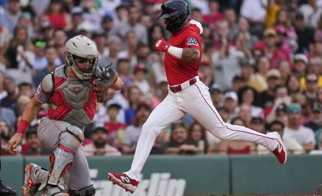 Boston Red Sox's Ceddanne Rafaela scores on a sacrifice by Romy Gonzalez against the Cincinnati Reds during the second inning of a baseball game at Fenway Park, Wednesday, July 2, 2025, in Boston. (AP Photo/Charles Krupa)