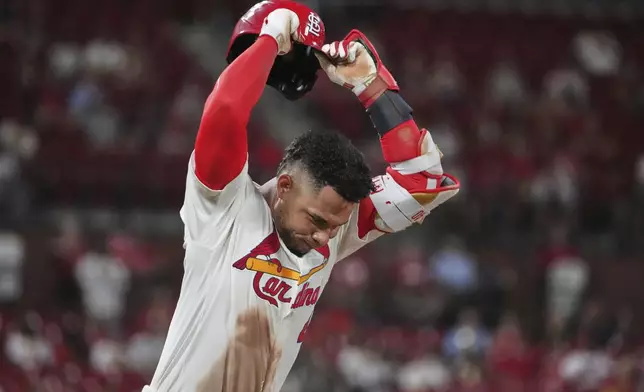 St. Louis Cardinals' Willson Contreras slams his down his helmet after flying out to end the seventh inning of a baseball game against the Washington Nationals Wednesday, July 9, 2025, in St. Louis. (AP Photo/Jeff Roberson)