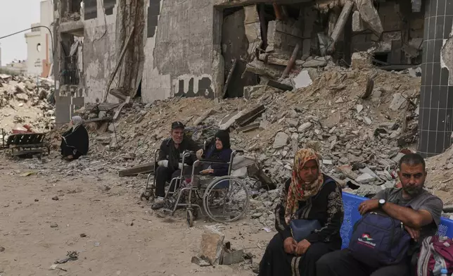 Kidney patients sit amid the destruction caused by the Israeli army at Shifa Hospital compound in Gaza City on Tuesday, July 1, 2025, as they wait to leave after the facility suspended its dialysis unit services due to fuel shortages needed to power its generators. (AP Photo/Jehad Alshrafi)