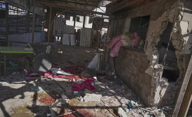 Blood, rubble, and what appears to be a giant stuffed doll lie scattered in a café after it was hit by an Israeli airstrike that killed more than 30 people near the port in Gaza City, Monday, June 30, 2025. (AP Photo/Jehad Alshrafi)