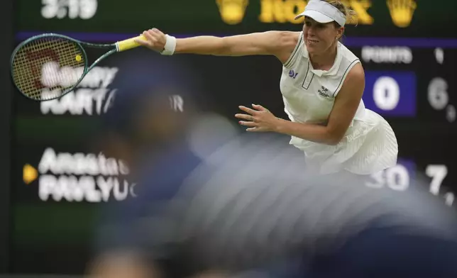 Russia's Anastasia Pavlyuchenkova serves to Sonay Kartal of Britain during a fourth round women's singles match at the Wimbledon Tennis Championships in London, Sunday, July 6, 2025. (AP Photo/Alastair Grant)