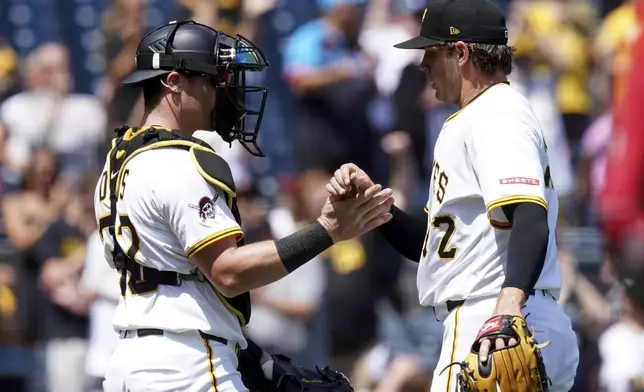 Pittsburgh Pirates pitcher Isaac Mattson, right, celebrates with catcher Henry Davis, after getting the final out of a baseball game against the St. Louis Cardinals, Wednesday, July 2, 2025, in Pittsburgh. (AP Photo/Matt Freed)