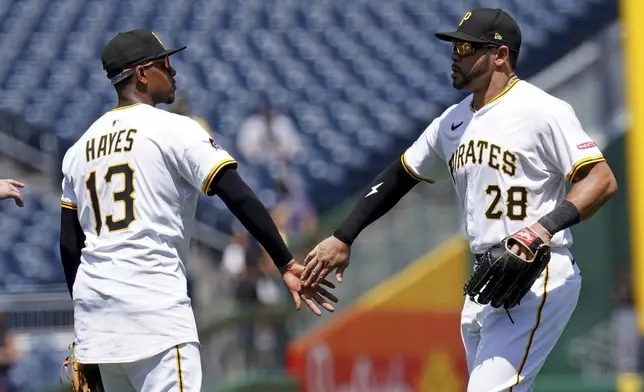 Pittsburgh Pirates third baseman Ke'Bryan Hayes, left, celebrates with left fielder Tommy Pham, after defeating the St. Louis Cardinals in a baseball game, Wednesday, July 2, 2025, in Pittsburgh. (AP Photo/Matt Freed)