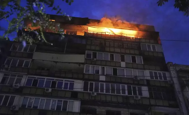 A fire burns at a residential building after a Russian attack in Kyiv, Ukraine, early Thursday, July 10, 2025. (AP Photo/Efrem Lukatsky)