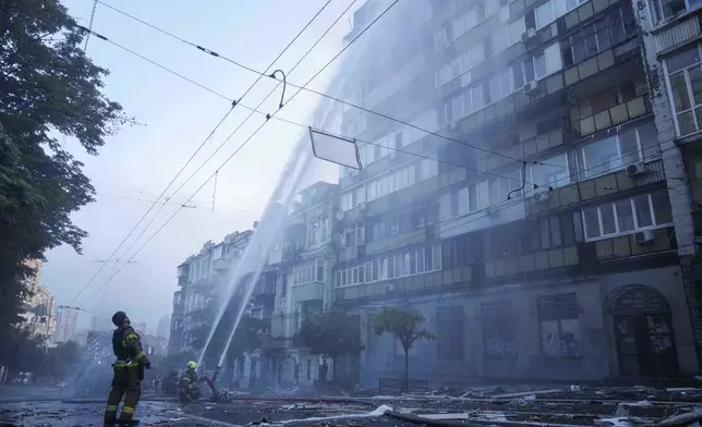 Rescue workers put out a fire of a residential house heavily damaged by a Russian strike in Kyiv, Ukraine, on Thursday, July 10, 2025. (AP Photo/Evgeniy Maloletka)