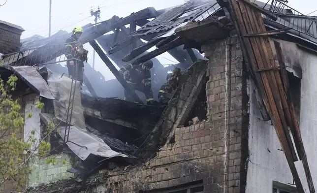 Firefighters work in a destroyed apartment building after a Russian attack in Kyiv, Ukraine, early Thursday, July 10, 2025. (AP Photo/Efrem Lukatsky)
