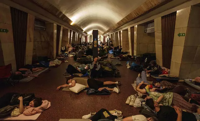 People sleep on the platform of a metro station as they take cover during a Russian attack on Kyiv, Ukraine, on Thursday, July 10, 2025. (AP Photo/Evgeniy Maloletka)
