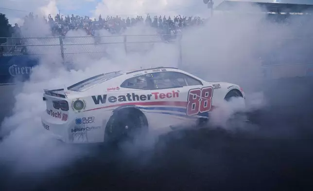 Shane van Gisbergen does a victory burnout after winning a NASCAR Cup Series auto race at the Grant Park 165, Sunday, July 6, 2025, in Chicago. (AP Photo/Erin Hooley)