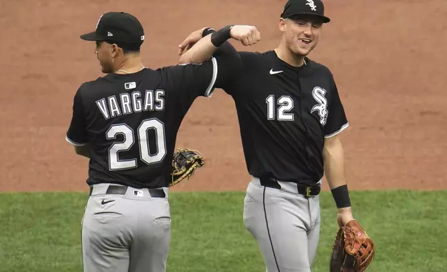 Chicago White Sox's Colson Montgomery (12) and Miguel Vargas (20) celebrate after getting the final out of a baseball game against the Pittsburgh Pirates in Pittsburgh, Sunday, July 20, 2025. (AP Photo/Gene J. Puskar)
