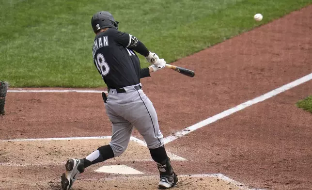Chicago White Sox's Mike Tauchman hits a double off Pittsburgh Pirates pitcher Andrew Heaney, driving in two runs, during the fifth inning of a baseball game in Pittsburgh, Sunday, July 20, 2025. (AP Photo/Gene J. Puskar)
