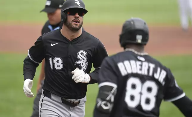 Chicago White Sox's Mike Tauchman (18) returns to the dugout after hitting solo home run off Pittsburgh Pirates pitcher Andrew Heaney during the first inning of a baseball game in Pittsburgh, Sunday, July 20, 2025. (AP Photo/Gene J. Puskar)
