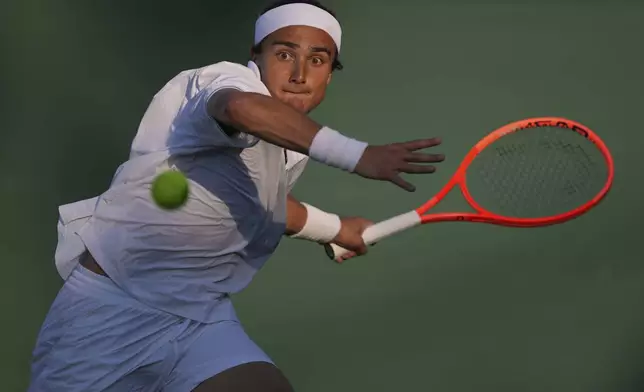 Mattia Bellucci of Italy plays a return to Jiri Lehecka of Czech Republic during the second round men's singles match at the Wimbledon Tennis Championships in London, Wednesday, July 2, 2025.(AP Photo/Kin Cheung)