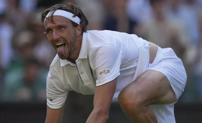 Arthur Rinderknech of France celebrates after beating Alexander Zverev of Germany in their first round men's singles match at the Wimbledon Tennis Championships in London, Tuesday, July 1, 2025. (AP Photo/Kin Cheung)