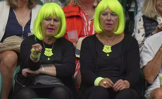 Spectators wait for play to start on Court 1 on day three at the Wimbledon Tennis Championships in London, Wednesday, July 2, 2025. (AP Photo/Alastair Grant)