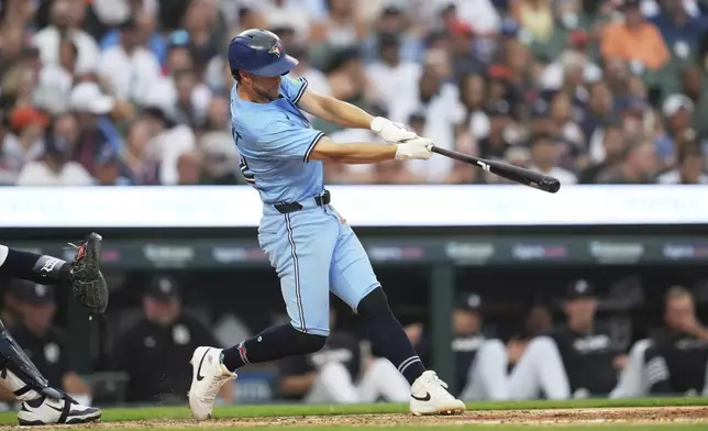 Toronto Blue Jays' Ernie Clement hits a three-run home run against the Detroit Tigers during the sixth inning of a baseball game Thursday, July 24, 2025, in Detroit. (AP Photo/Paul Sancya)