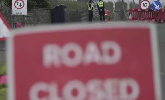 Police officers stand at a checkpoint near the Trump Turnberry golf course in Turnberry, Scotland, Wednesday, July 23, 2025, ahead of President Trump's expected visit Scotland later this week. (AP Photo/Alastair Grant)
