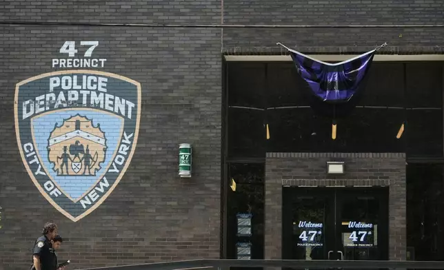 New York Police officers arrive at the NYPD 47th Precinct where NYPD officer Didarul Islam, who was killed Monday, served, in the Bronx borough of New York, Tuesday, July 29, 2025. (AP Photo/Seth Wenig)