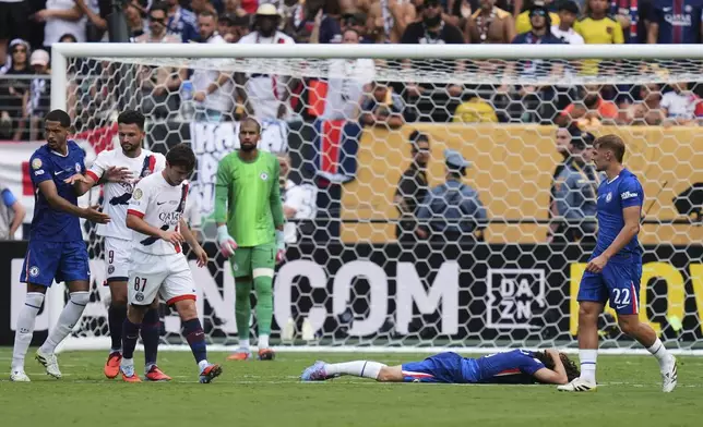 Chelsea's Marc Cucurella (3) lies on the pitch after foul by Paris Saint-Germain's Joao Neves (87) during the Club World Cup final soccer match between Chelsea and PSG in East Rutherford, N.J., Sunday, July 13, 2025. (AP Photo/Seth Wenig)