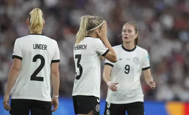 Germany's Kathrin Hendrich reacts after seeing a red card for pulling the hair of France's Griedge Mbock Bathy during the Women's Euro 2025 quarterfinals soccer match between France and Germany at St. Jakob-Park in Basel, Switzerland, Saturday, July 19, 2025. (AP Photo/Alessandra Tarantino)