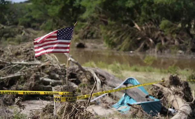 FILE - An American flag is placed on a stump flies in Kerrville, Texas on July 8, 2025. (AP Photo/Ashley Landis, file)
