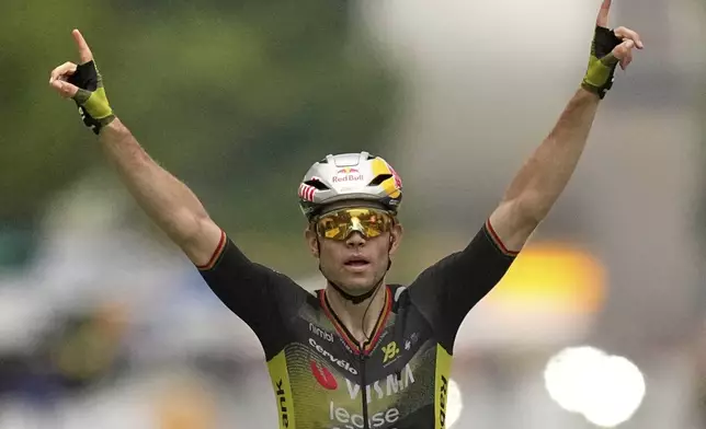 Belgium's Wout van Aert crosses the finish line to win the twenty-first stage of the Tour de France cycling race over 132.3 kilometers (82.1 miles) with start in Mantes-la-Ville and finish on the Champs-Elysees in Paris, France, Sunday, July 27, 2025. (AP Photo/Thibault Camus)