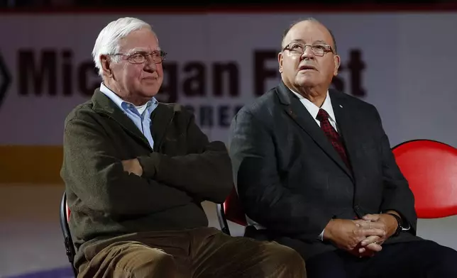 FILE - Former Detroit Red Wings player Alex Delvecchio, left, and former head coach Scotty Bowman listen during a ceremony to retire Red Kelly's number 4 before an NHL hockey game against the Toronto Maple Leafs, Feb. 1, 2019, in Detroit. (AP Photo/Paul Sancya, File)