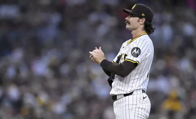 San Diego Padres starting pitcher Dylan Cease looks on after a grand slam home run by Arizona Diamondbacks' Geraldo Perdomo during the fifth inning of a baseball game Wednesday, July 9, 2025, in San Diego. (AP Photo/Orlando Ramirez)
