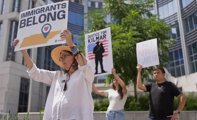 Linda McFadyen-Ketchum, left, holds a protest sign outside the federal courthouse Wednesday, July 16, 2025, in Nashville, Tenn. (AP Photo/George Walker IV)