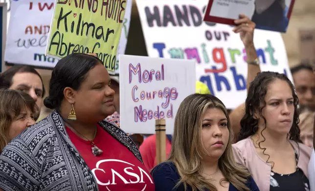 Jennifer Vasquez Sura, center, the wife of Kilmar Abrego Garcia, joins supporters of Abrego Garcia as they rally outside of the U.S. District Court in Greenbelt, Md., where a hearing was scheduled to be held on returning him to Maryland, Monday, July 7, 2025. (AP Photo/Mark Schiefelbein)