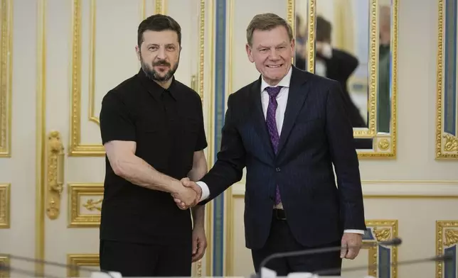 In this photo provided by the Ukrainian Presidential Press Office, Ukrainian President Volodymyr Zelenskyy, left, shakes hands with German Foreign Minister Johann Wadephul in Kyiv, Ukraine, Monday, June 30, 2025. (Ukrainian Presidential Press Office via AP)