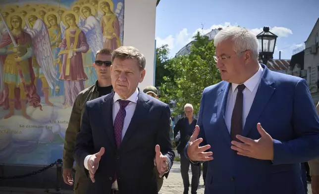 German Foreign Minister Johann Wadephul, left, and Ukrainian Foreign Minister Andrii Sybiha stand at the entrance of St. Michael Monastery in Kyiv, Ukraine, Monday, June 30, 2025. (AP Photo/Efrem Lukatsky)