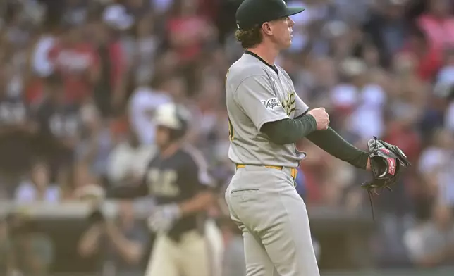 Athletics starting pitcher JP Sears waits for Cleveland Guardians' David Fry to run the bases after hitting a two-run home run during the third inning of a baseball game, Friday, July 18, 2025, in Cleveland. (AP Photo/David Dermer)