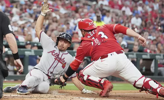 Atlanta Braves' Drake Baldwin, left, is tagged out at home by St. Louis Cardinals catcher Pedro Pages during the third inning of a baseball game Friday, July 11, 2025, in St. Louis. (AP Photo/Jeff Roberson)