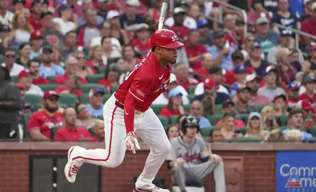 St. Louis Cardinals' Willson Contreras follows through on an RBI single during the first inning of a baseball game against the Atlanta Braves Friday, July 11, 2025, in St. Louis. (AP Photo/Jeff Roberson)