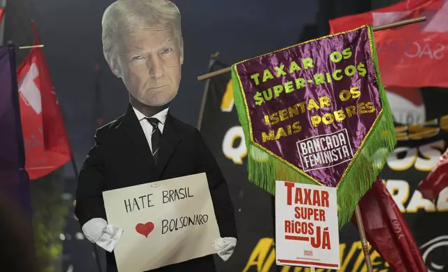 Protesters hold up an effigy of U.S. President Donald Trump in response to Trump's announcement of 50% tariffs on Brazilian goods, in Sao Paulo, Thursday, July 10, 2025. (AP Photo/Andre Penner)