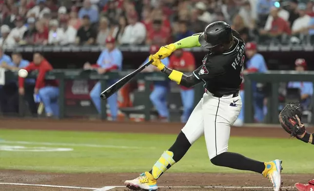 Arizona Diamondbacks' Geraldo Perdomo connects for a run-scoring single against the St. Louis Cardinals during the first inning of a baseball game Saturday, July 19, 2025, in Phoenix. (AP Photo/Ross D. Franklin)