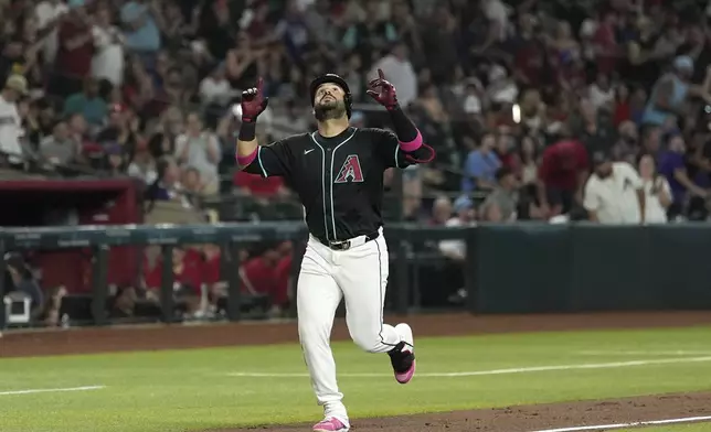 Arizona Diamondbacks' Eugenio Suárez looks up as he rounds the bases after hitting a home run against the St. Louis Cardinals during the third inning of a baseball game, his second of the game, Saturday, July 19, 2025, in Phoenix. (AP Photo/Ross D. Franklin)