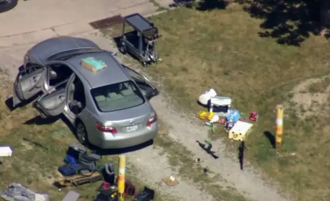 This aerial image taken from video provided by WEWS shows police working at the scene of shooting after police officers were wounded and a man was killed in an exchange of gunfire early Wednesday afternoon, July 23, 2025, in an industrial area of Lorain, Ohio. (WEWS via AP)