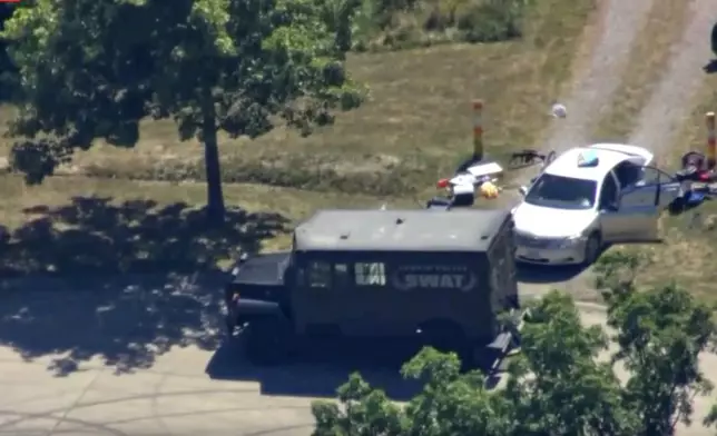 This aerial image taken from video provided by WEWS shows police working at the scene of shooting after police officers were wounded and a man was killed in an exchange of gunfire early Wednesday afternoon, July 23, 2025, in an industrial area of Lorain, Ohio. (WEWS via AP)