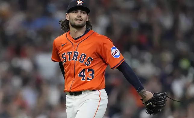 Houston Astros starting pitcher Lance McCullers Jr. (43) reacts after fielding a base hit during the third inning of a baseball game against the Texas Rangers, Friday, July 11, 2025, in Houston. (AP Photo/Kevin M. Cox)