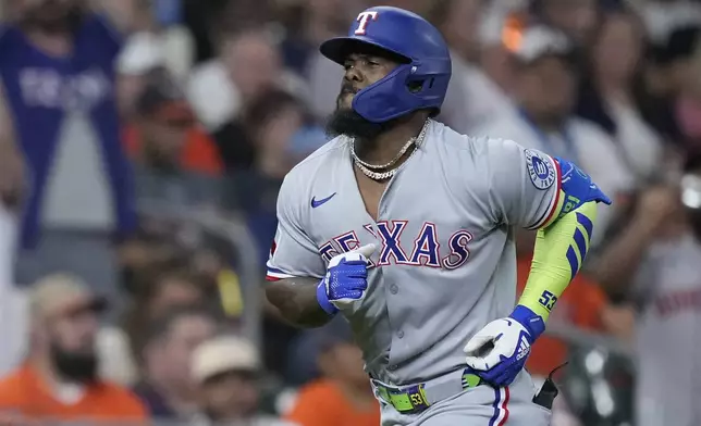 Texas Rangers' Adolis García runs the bases after hitting a solo home run during the third inning of a baseball game against the Houston Astros, Friday, July 11, 2025, in Houston. (AP Photo/Kevin M. Cox)
