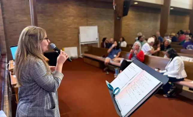 A woman leads a breakout session during a training hosted by Undivided at Central Christian Church in Springfield, Ohio, aimed at teaching community and church leaders how to support and shelter immigrants facing deportation, Tuesday, July 29, 2025. (AP Photo/Obed Lamy)
