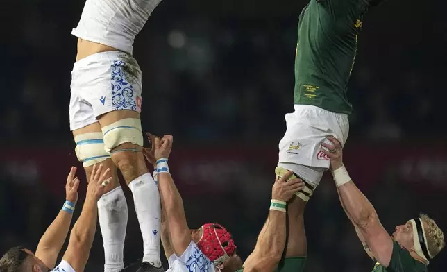 Italy's Andrea Zambonin, top, left, wins a line out against South Africa's Vincent Tshituka, right, during a rugby championship test match between South Africa and Italy, at Loftus Versfeld stadium in Pretoria, South Africa, Saturday, July 5, 2025. (AP Photo/Themba Hadebe)