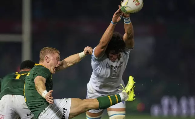 South Africa's Morne van den Berg, left, kicks the ball as Italy's Andrea Zambonin tries to block the ball during a rugby championship test match between South Africa and Italy, at Loftus Versfeld stadium in Pretoria, South Africa, Saturday, July 5, 2025. (AP Photo/Themba Hadebe)