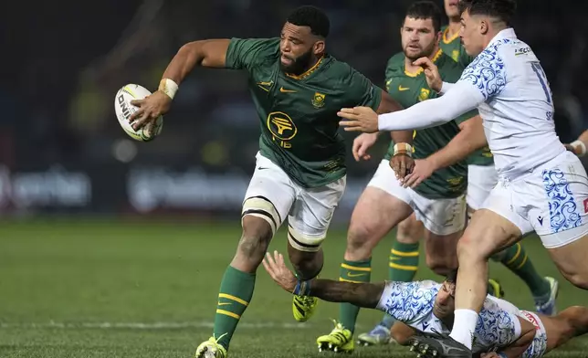 South Africa's Vincent Tshituka, left, passes the ball during a rugby championship test match between South Africa and Italy, at Loftus Versfeld stadium in Pretoria, South Africa, Saturday, July 5, 2025. (AP Photo/Themba Hadebe)