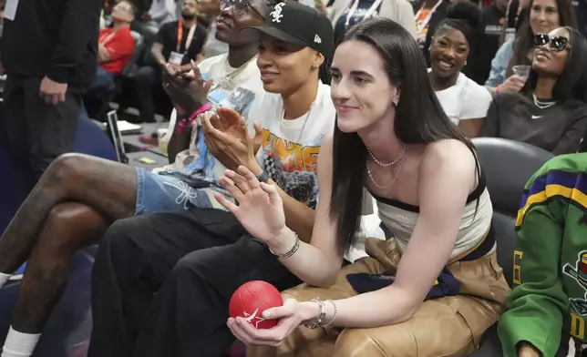Indiana Fever's Caitlin Clark waves during the 3-point contest at the WNBA All-Star basketball weekend, Friday, July 18, 2025, in Indianapolis. (AP Photo/Michael Conroy)