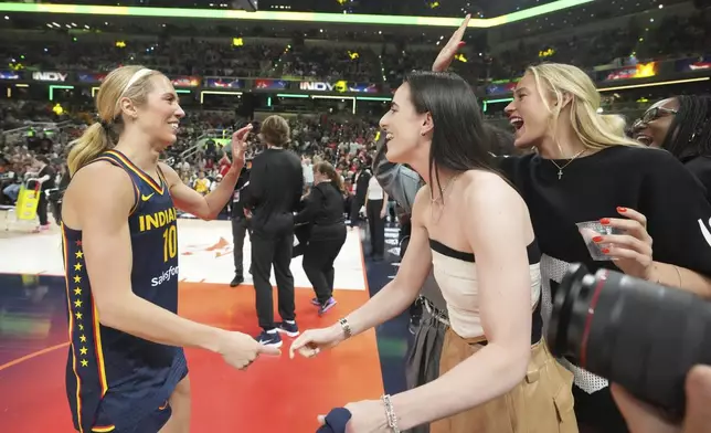 Indiana Fever's Lexi Hull is congratulated by Caitlin Clark and Sophie Cunningham after shooting in the 3-point contest at the WNBA All-Star basketball weekend, Friday, July 18, 2025, in Indianapolis. (AP Photo/Michael Conroy)