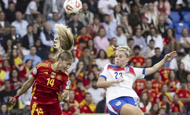 England's Alessia Russo, right, scores past Spain's Laia Aleixandri, left, during the Women's Euro 2025 final soccer match between England and Spain at St. Jakob-Park in Basel, Switzerland, Sunday, July 27, 2025. (Jean-Christophe Bott/Keystone via AP)