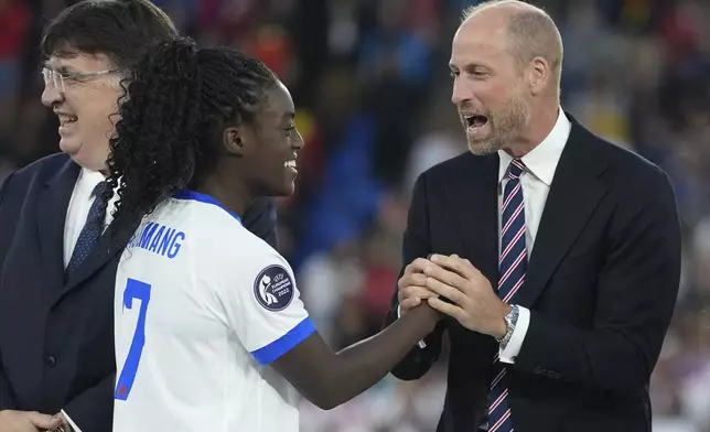 Britain's Prince William congratulates to England's Michelle Agyemang after the Women's Euro 2025 final soccer match between England and Spain at St. Jakob-Park in Basel, Switzerland, Sunday, July 27, 2025. (AP Photo/Martin Meissner)
